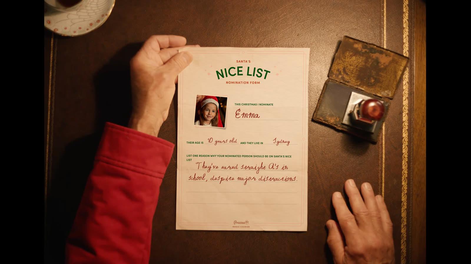 A completed Santa’s Nice List nomination form sitting on a wooden desk at the North Pole